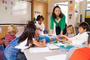 Celebrate Teachers! Teacher teaching elementary kids with block play in class
