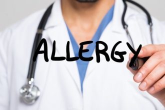Doctor writing the word Allergy