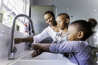 Healthy Habits - Family washing their hands together.