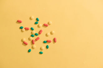 Opioids - Colorful pills on yellow background