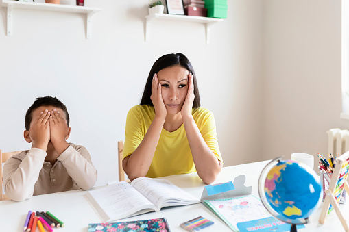Get Homework Tips Little Boy With Problems During Meeting With Therapist. Stressed Mother and Son Frustrated Over Homework
