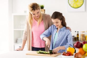 Mom teaching teen daughter to cook