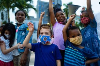 diverse children protesting against racism