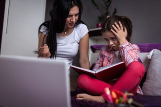 Frustrated young girl struggling with distance learning