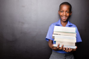 black boy holding school books