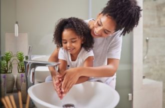 Mom washing hands with daughter