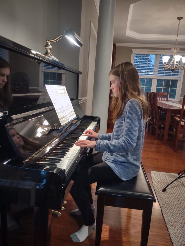 Paige Opaska playing piano.
