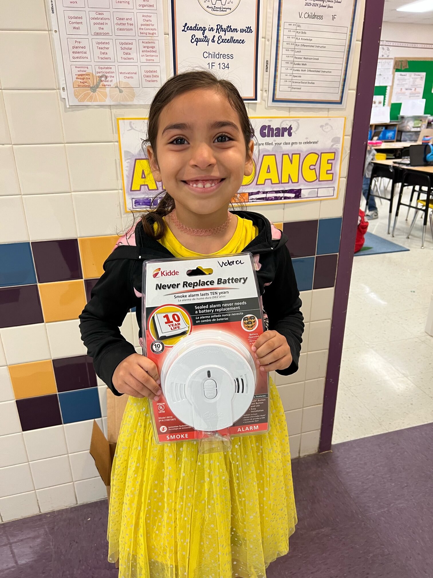 Student holding smoke detector