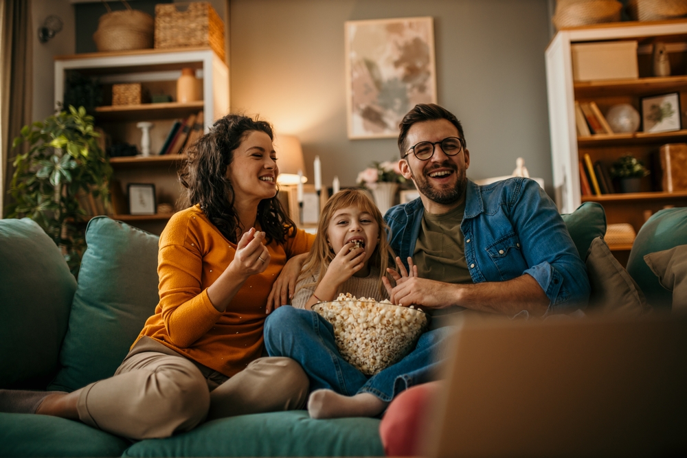 Parents watching movie with daughter