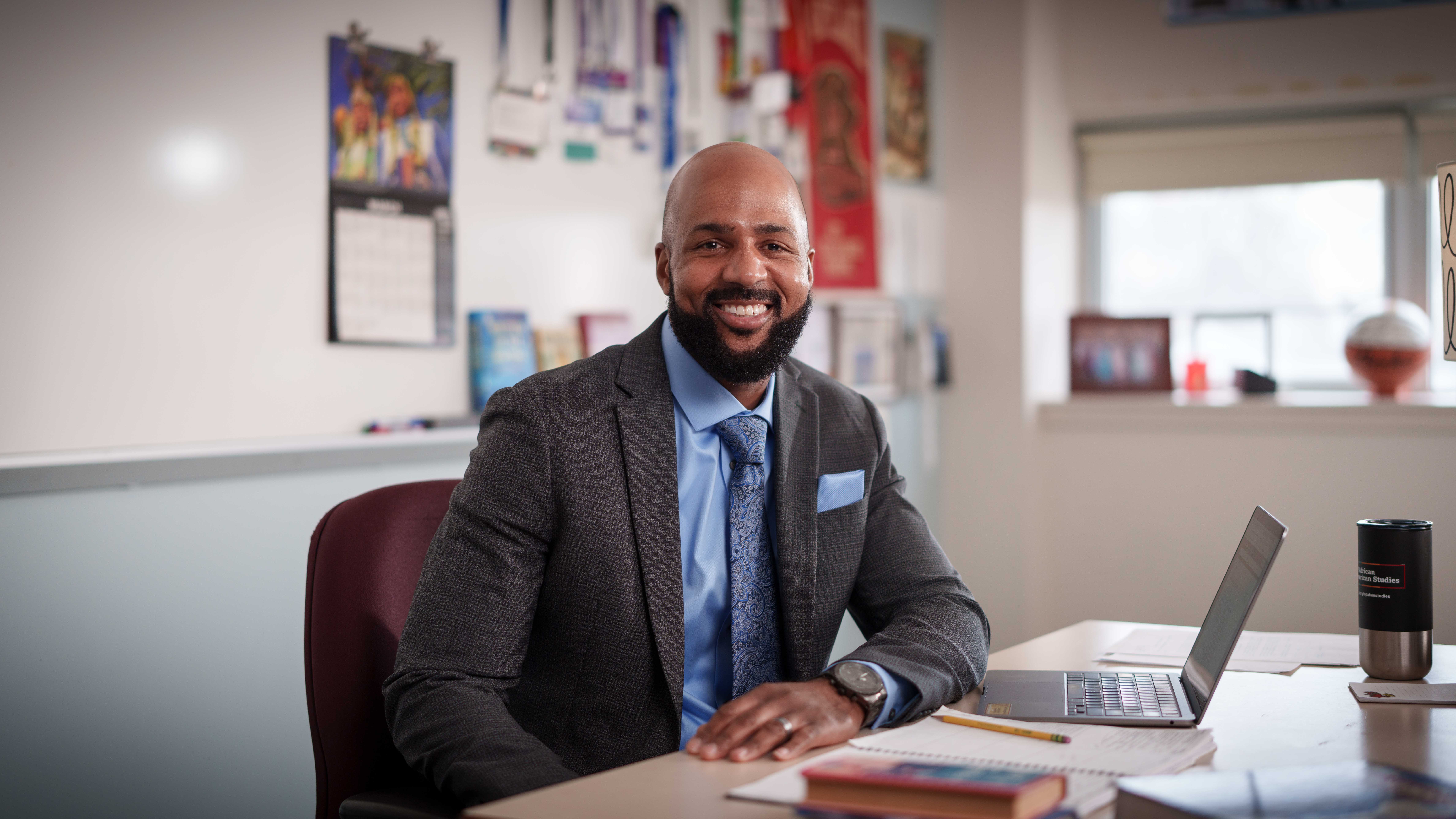 Leon Smith in the classroom at his desk - teacher of the year